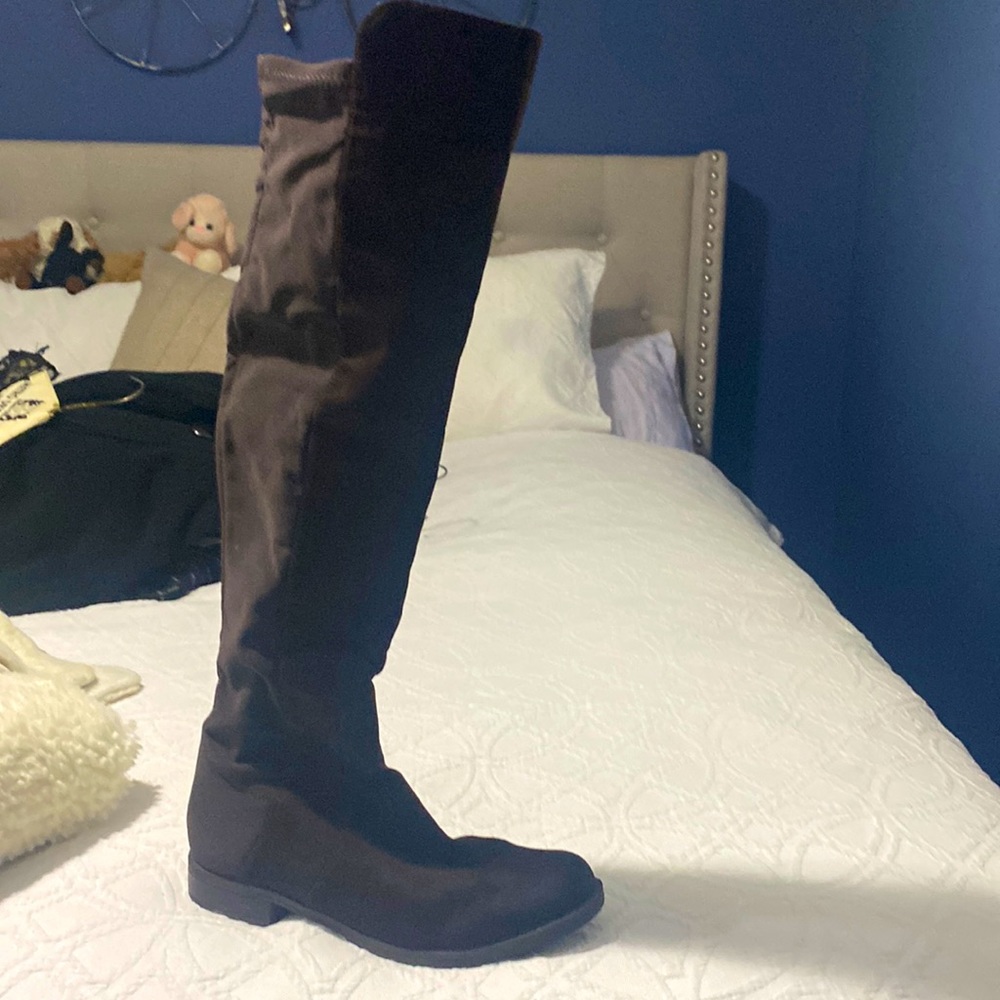 Brown suede over the knee boots .